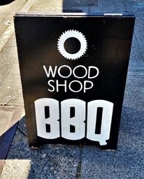 Small sign out front of Wood Shop BBQ