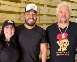 Guy Fieri with the owners