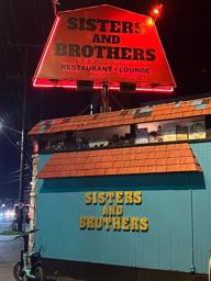 Out front of the new location for Sisters and Brothers