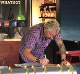 pic of guy fieri leaving his signature on a pan