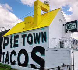 pietown tacos logo on the side of a wall