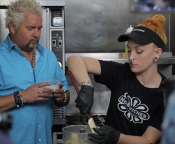 Another shot of Guy Fieri cooking with Chef Nora