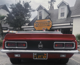 that sexy red car looks mighty good in front our doors
