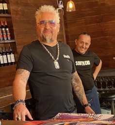 guy fieri styling and signing posters